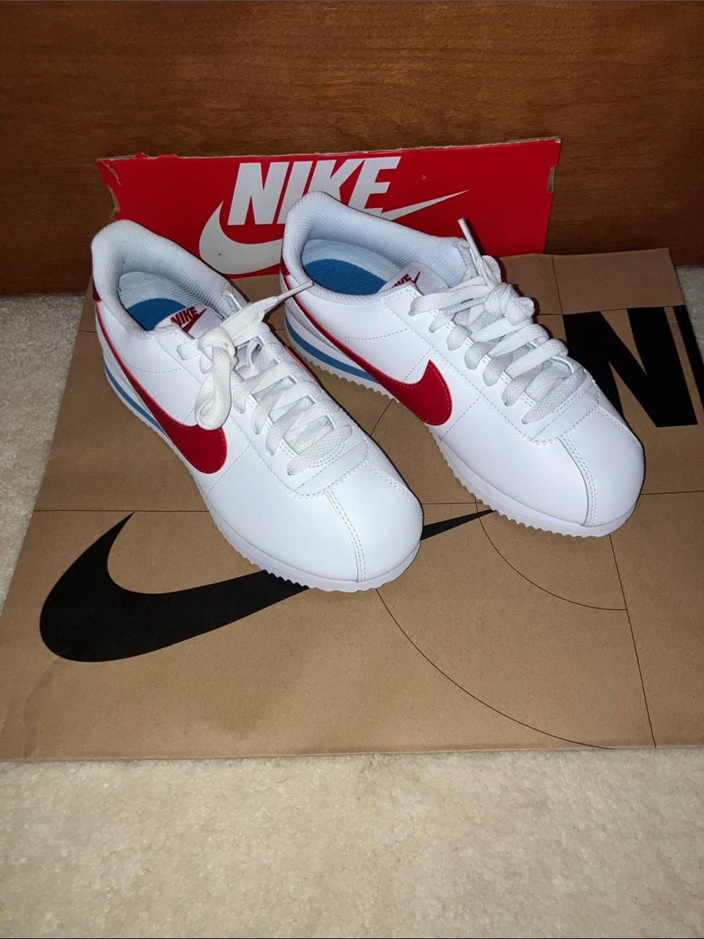 Nike White Sneakers with Red Swoosh and Blue Heel Accent